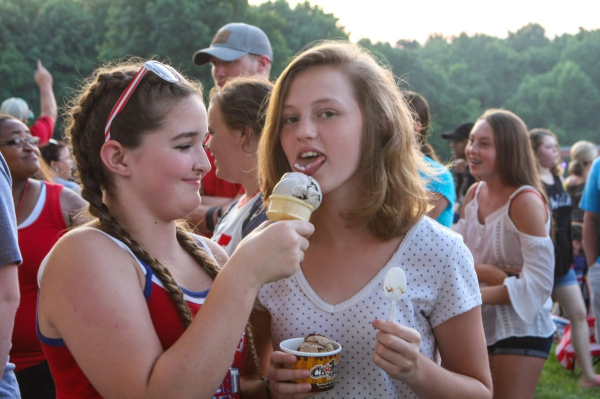 Friends share a sweet treat at The Hayward Minton Thunderfest, enjoying ice cream and summer fun.