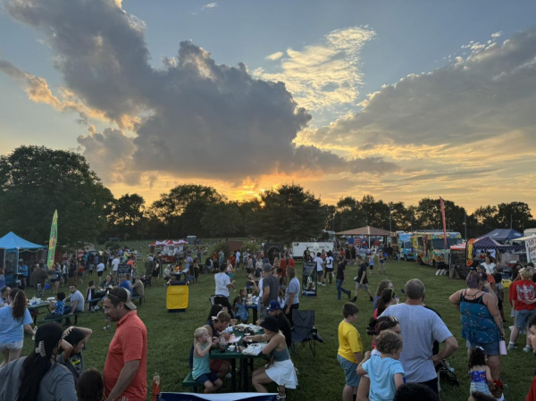 As the sun sets, families and friends fill the lawn at The Hayward Minton Thunderfest, enjoying food, fun, and community before the fireworks begin.