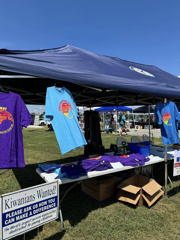 The Kiwanis Club tent at The Hayward Minton Thunderfest, featuring event t-shirts, raffle tickets, and info on how to get involved.
