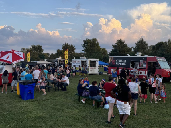 Festival-goers line up at food trucks during The Hayward Minton Thunderfest, enjoying local eats and summer evening vibes.