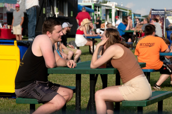 A couple shares a quiet conversation amid the energy and excitement of Thunderfest.