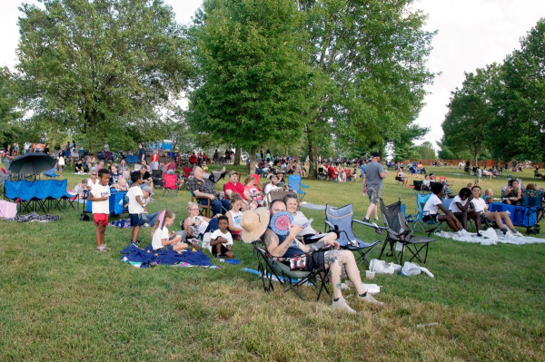 Families and friends enjoying the sunshine, music, and memories on the hill at Ephram White Park.
