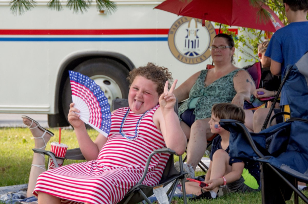 Red, white, and full of personality! A young festival-goer shows off their patriotic pride.
